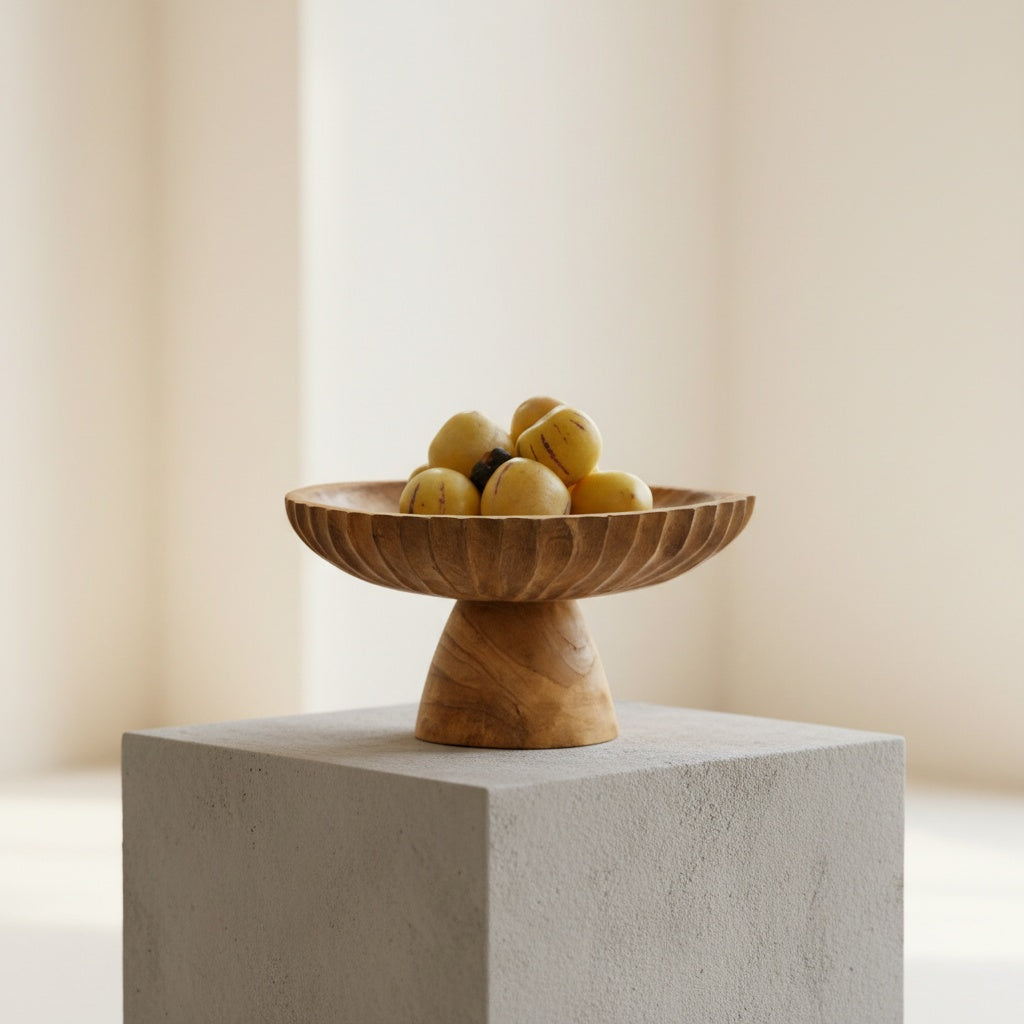 Wooden pedestal fruit bowl on office desk with books