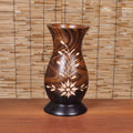 Front view of hand-carved dark wood vase with floral design