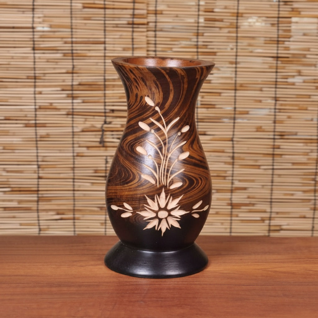Front view of hand-carved dark wood vase with floral design