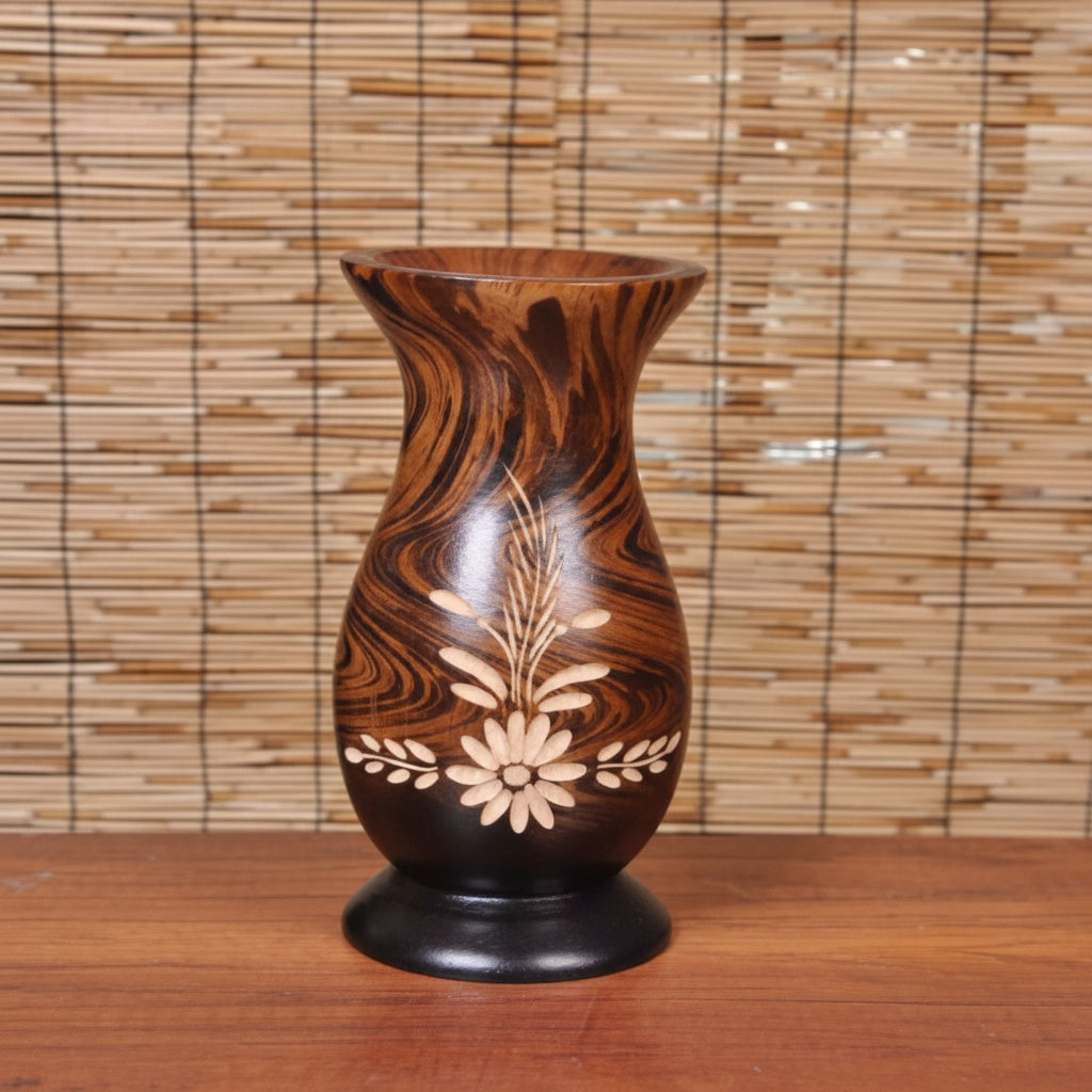 Angled view of wooden vase showing curved silhouette and carving details