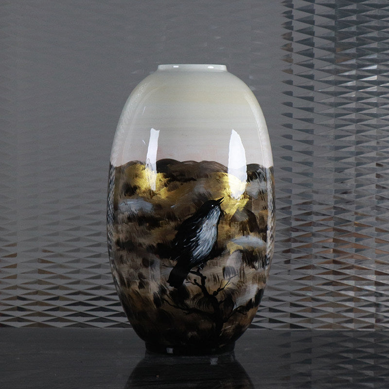Hand painted ceramic vase with bird motif and gold accents