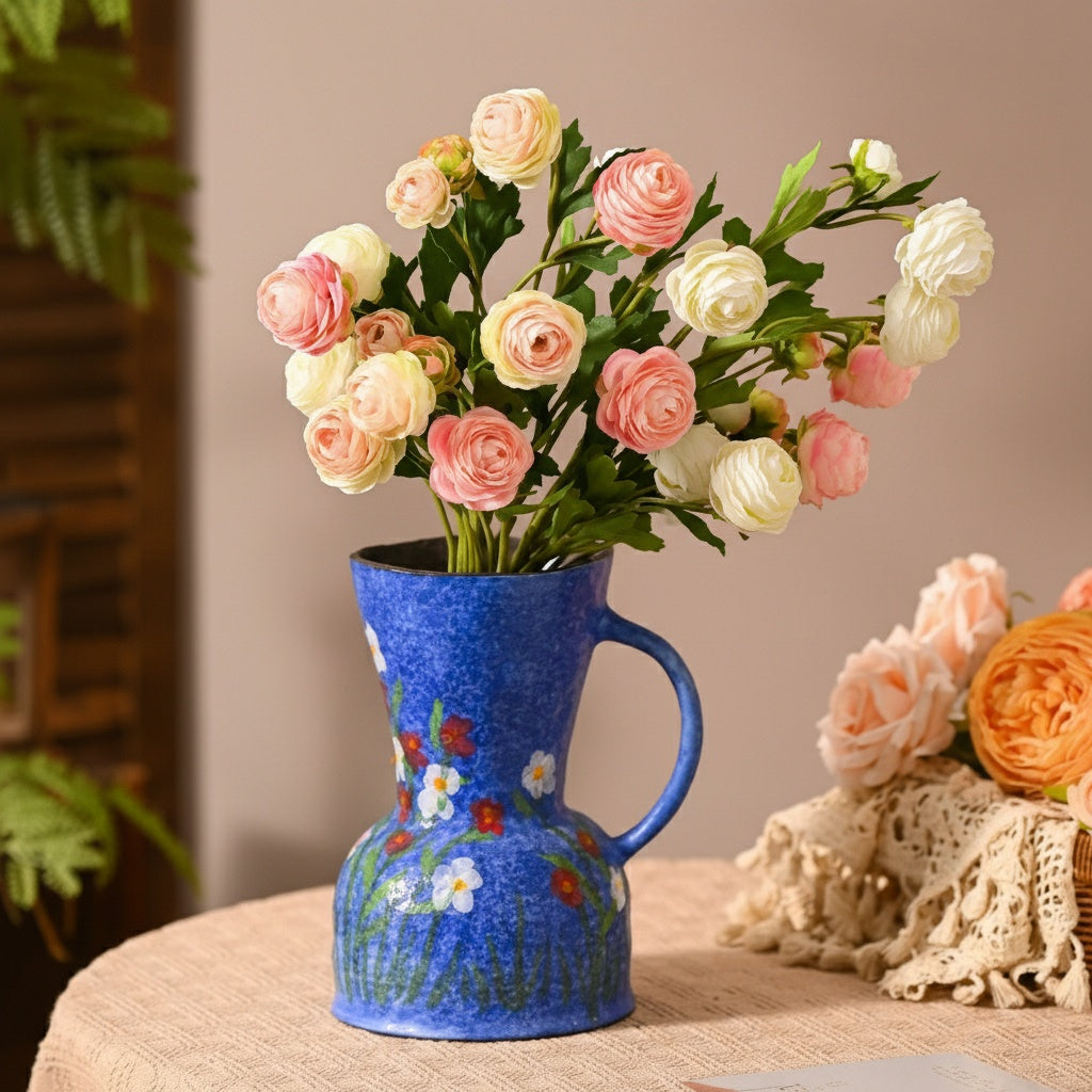 Blue ceramic vase with pink flowers