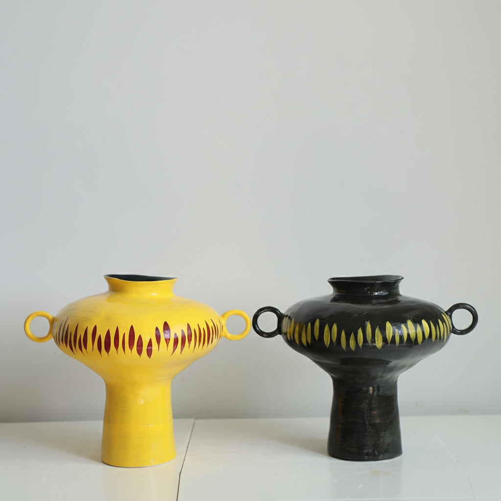 Ceramic vases in yellow and black side by side