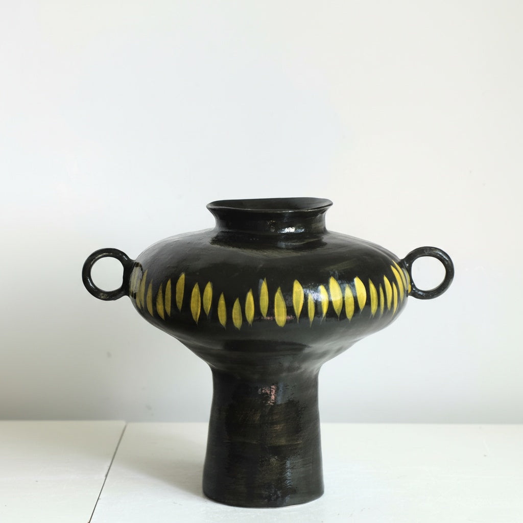 Black ceramic vase with yellow dash pattern