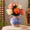 Hand-painted ceramic vase with blue floral design and twin handles