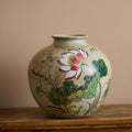 Front view of hand-painted ceramic round vase with lotus motif