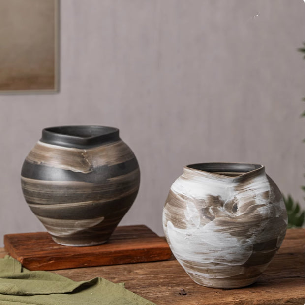 Black and white hand-painted ceramic vases side by side