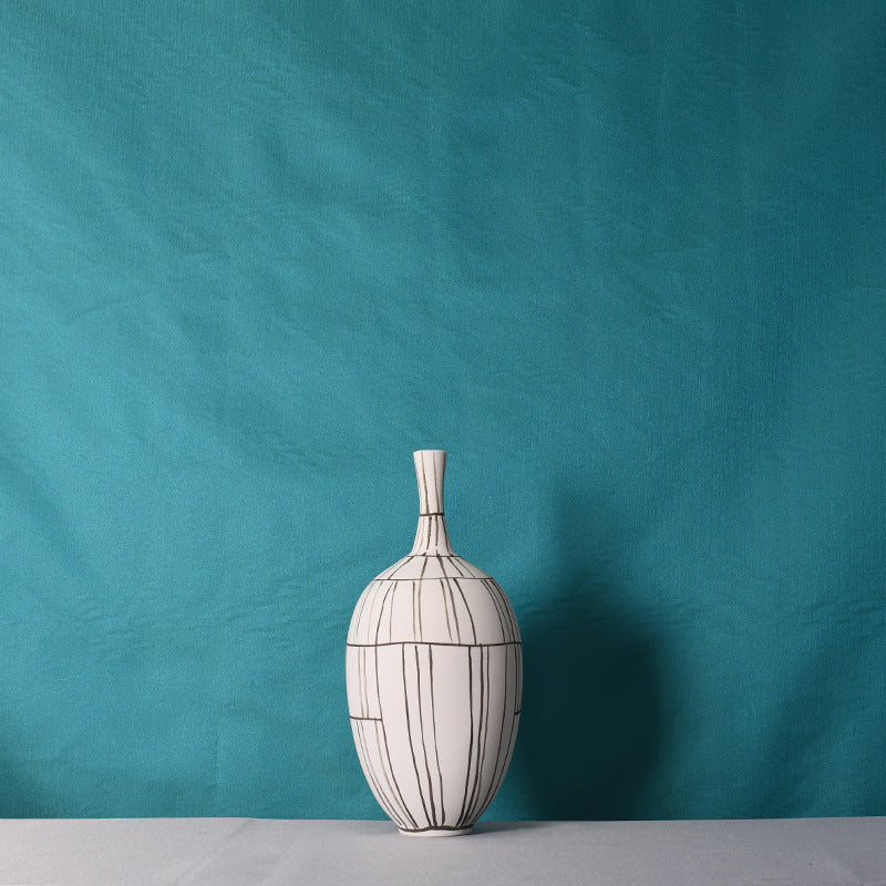 Front view of the large white ceramic vase with black grid lines