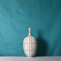 Front view of the medium white ceramic vase with black grid lines