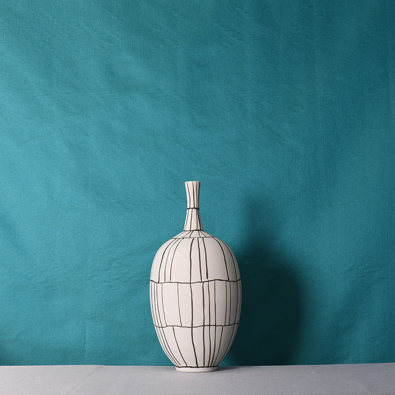 Front view of the medium white ceramic vase with black grid lines