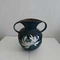 Front view of blue ceramic vase with white lotus design