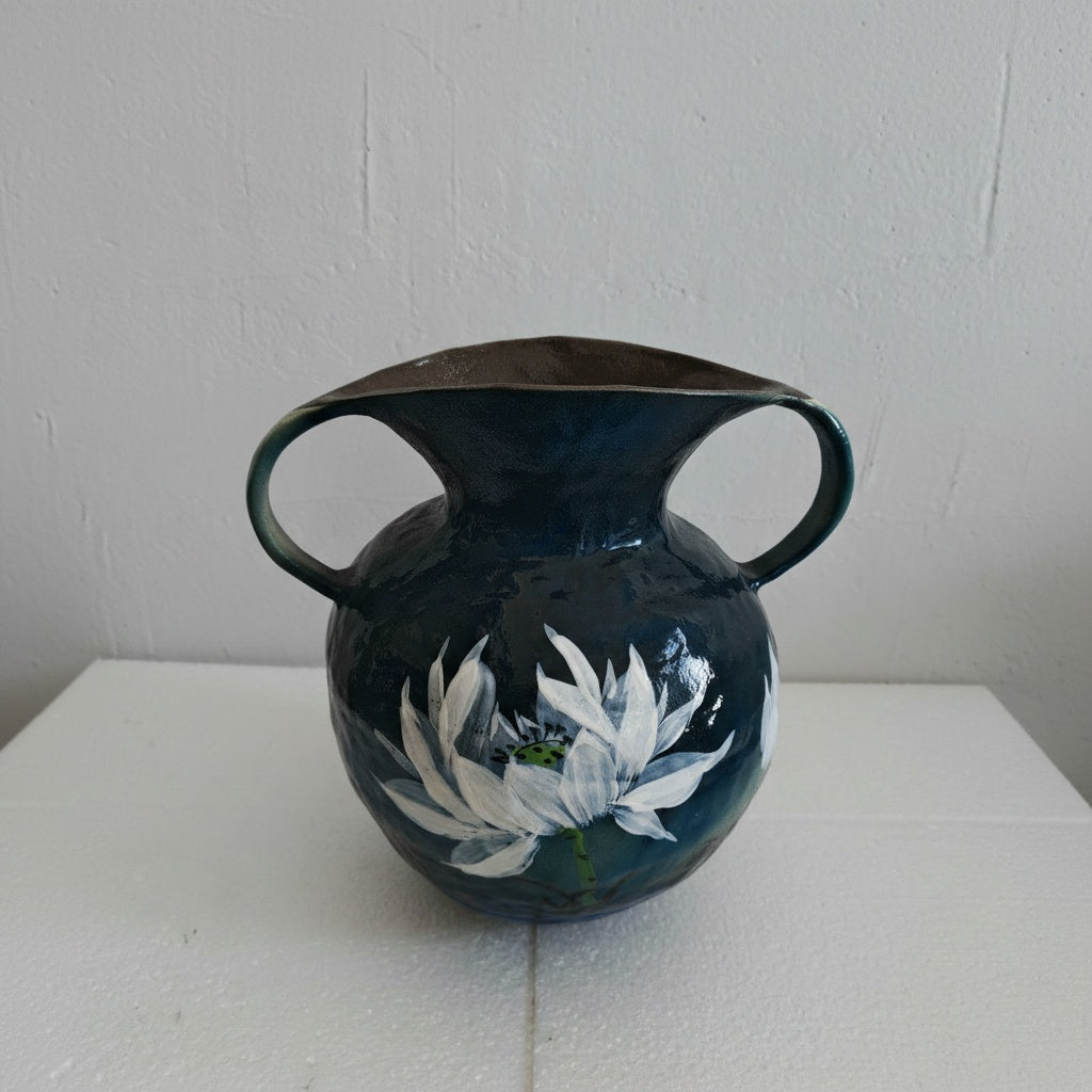 Front view of blue ceramic vase with white lotus design