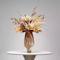 Front view of hand-painted ceramic vase with autumnal faux floral arrangement