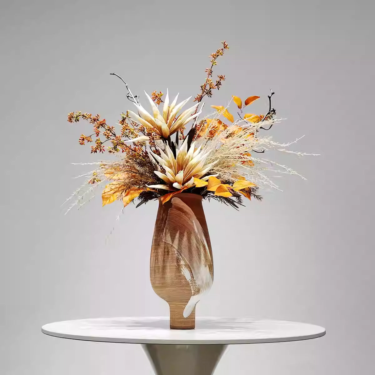 Front view of hand-painted ceramic vase with autumnal faux floral arrangement