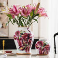 Two floral porcelain vessels with purple lily design