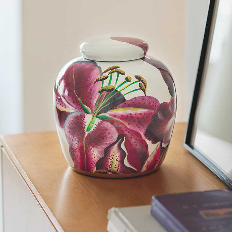 Decorative floral jar displayed on a wooden console table