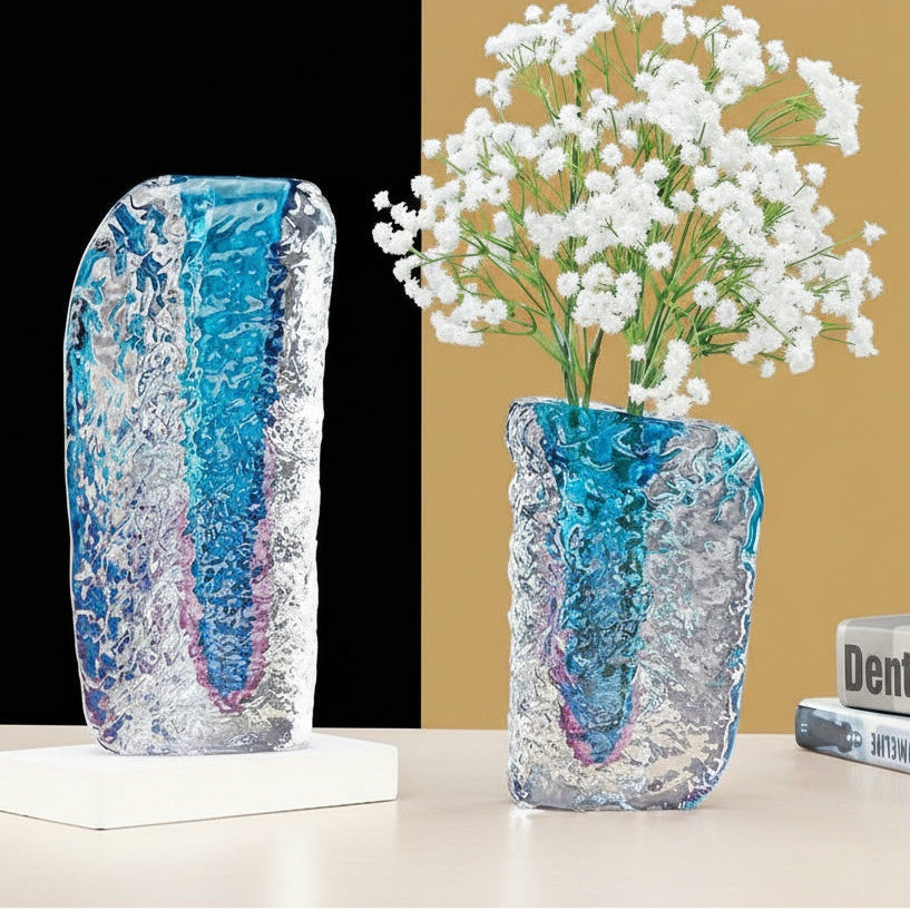 Ice textured glass vase with blue and purple core holding white flowers