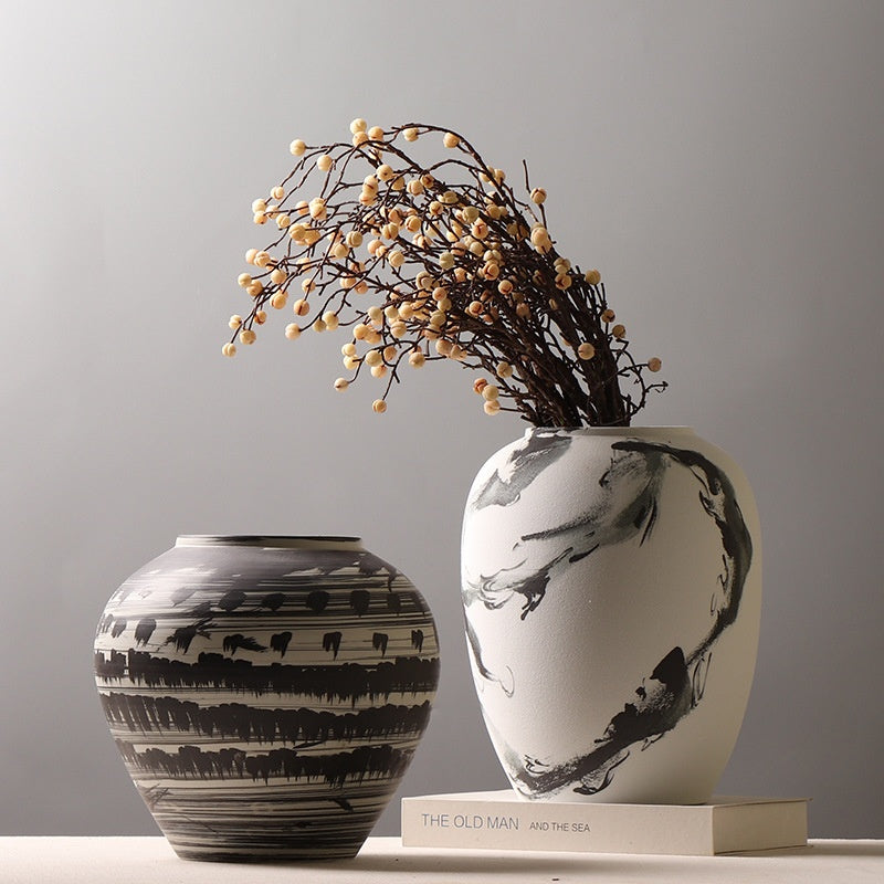 Two black and white ceramic vases with ink wash patterns