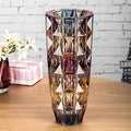 Front view of iridescent faceted glass vase with amber to purple gradient