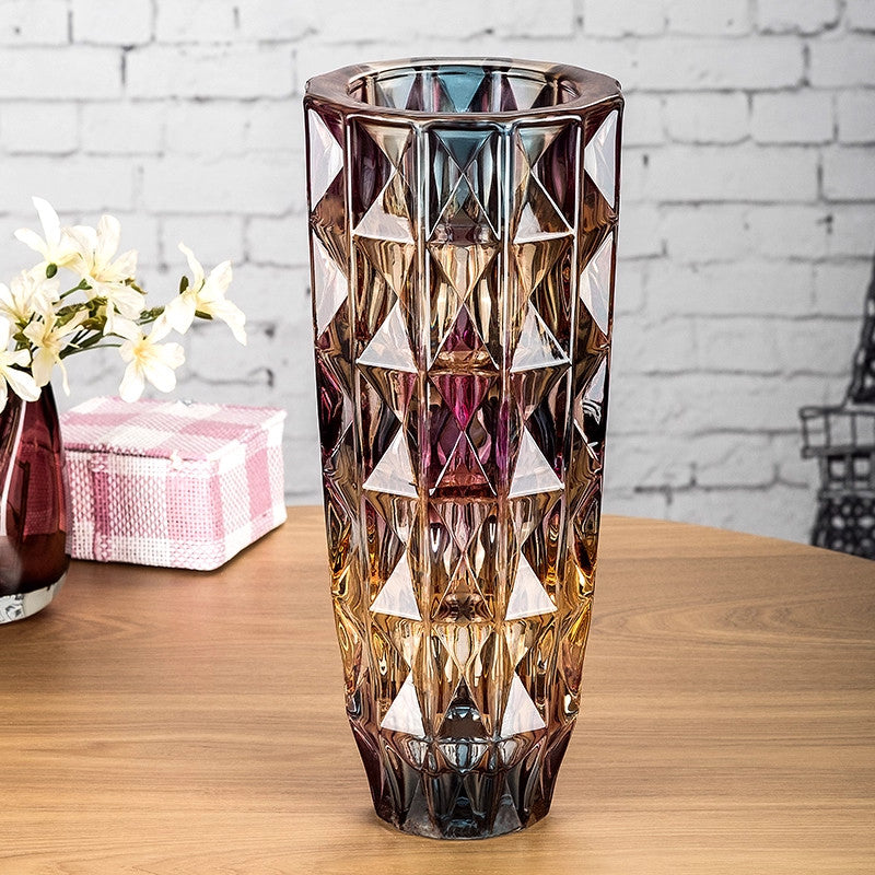 Front view of iridescent faceted glass vase with amber to purple gradient