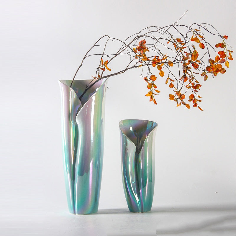 Two iridescent vases with organic folded shapes and dried branches