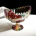 Footed iridescent glass bowl with scalloped rim front view