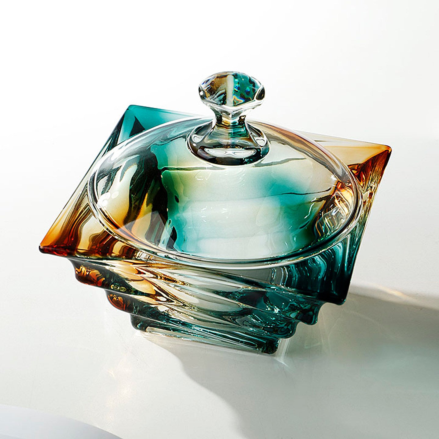 High angle view of square sculpted glass jar showing gradient colors