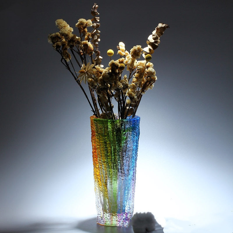 Iridescent textured glass vase with floral arrangement