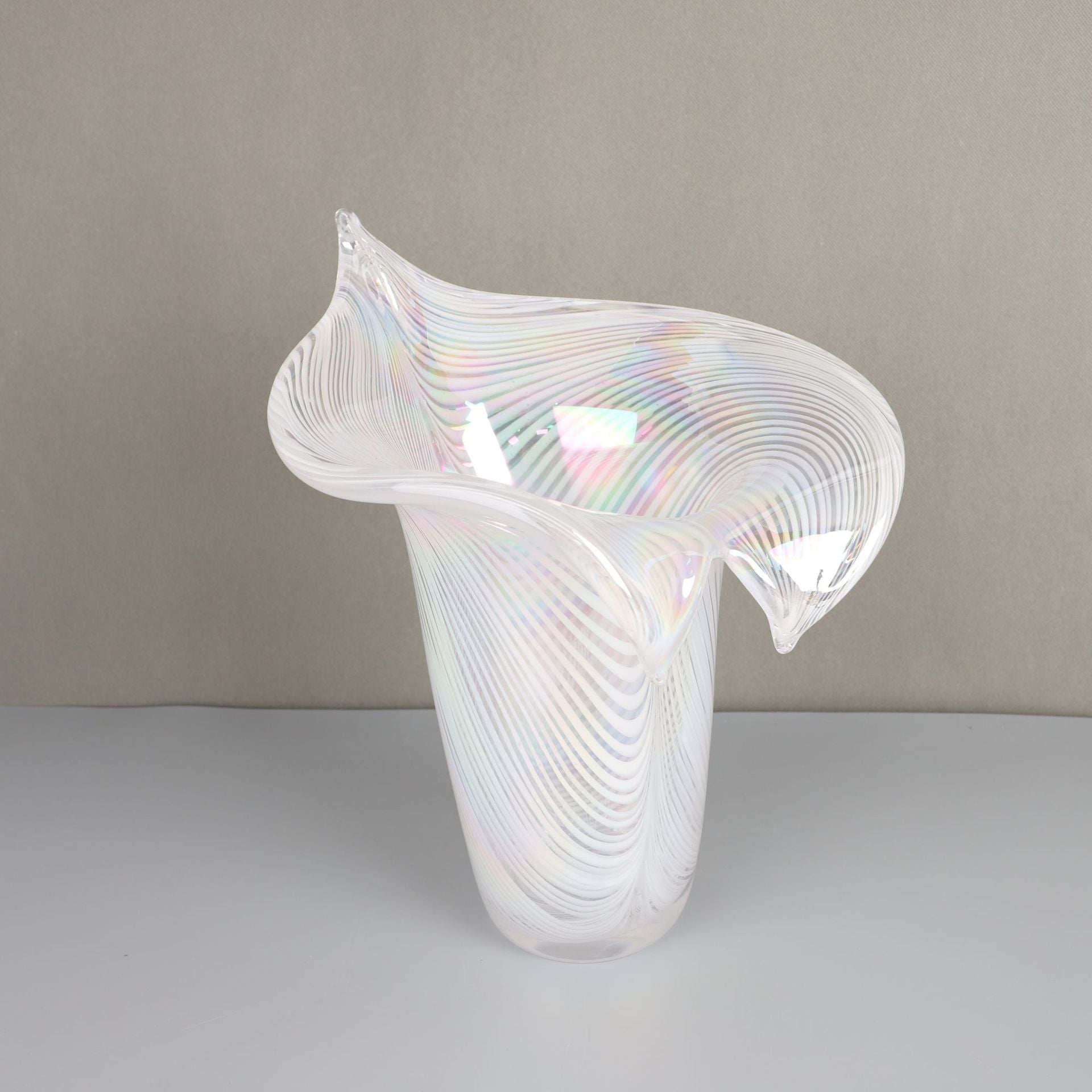 Top angle view of pearlescent white swirl glass vase