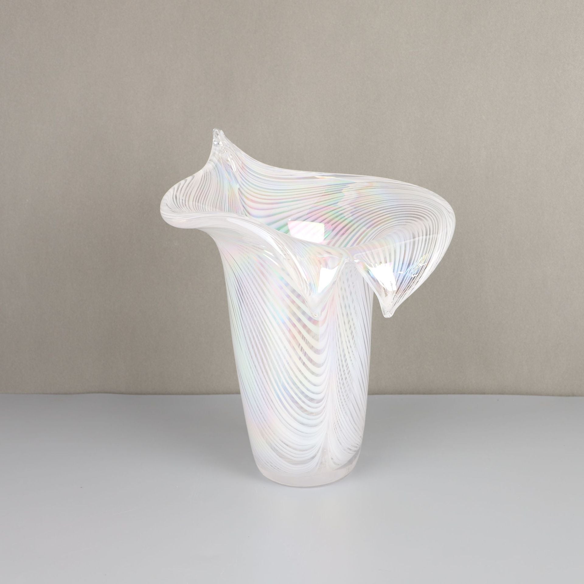 Side view of iridescent white glass flared vase