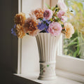 Ivory Ceramic Fluted Floral Vase with flowers on a windowsill