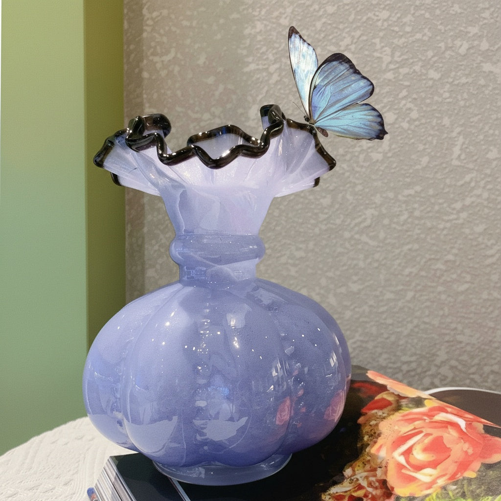 Detail of lavender glass vase rim with butterfly prop