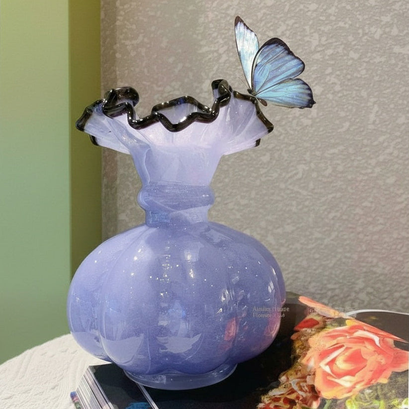 Lavender ribbed glass vase on book stack
