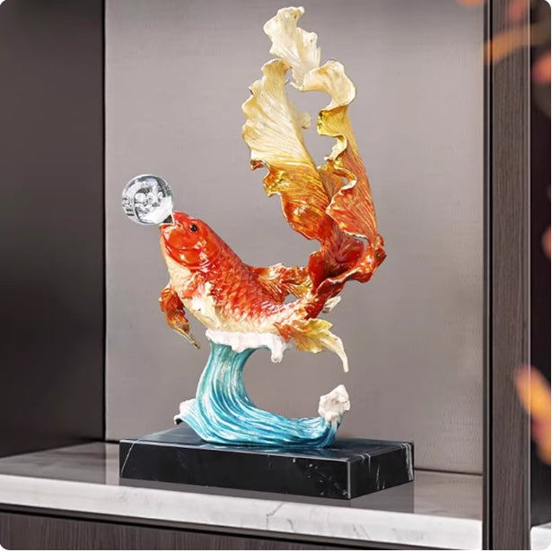 Side profile of vibrant orange and gold koi fish statue