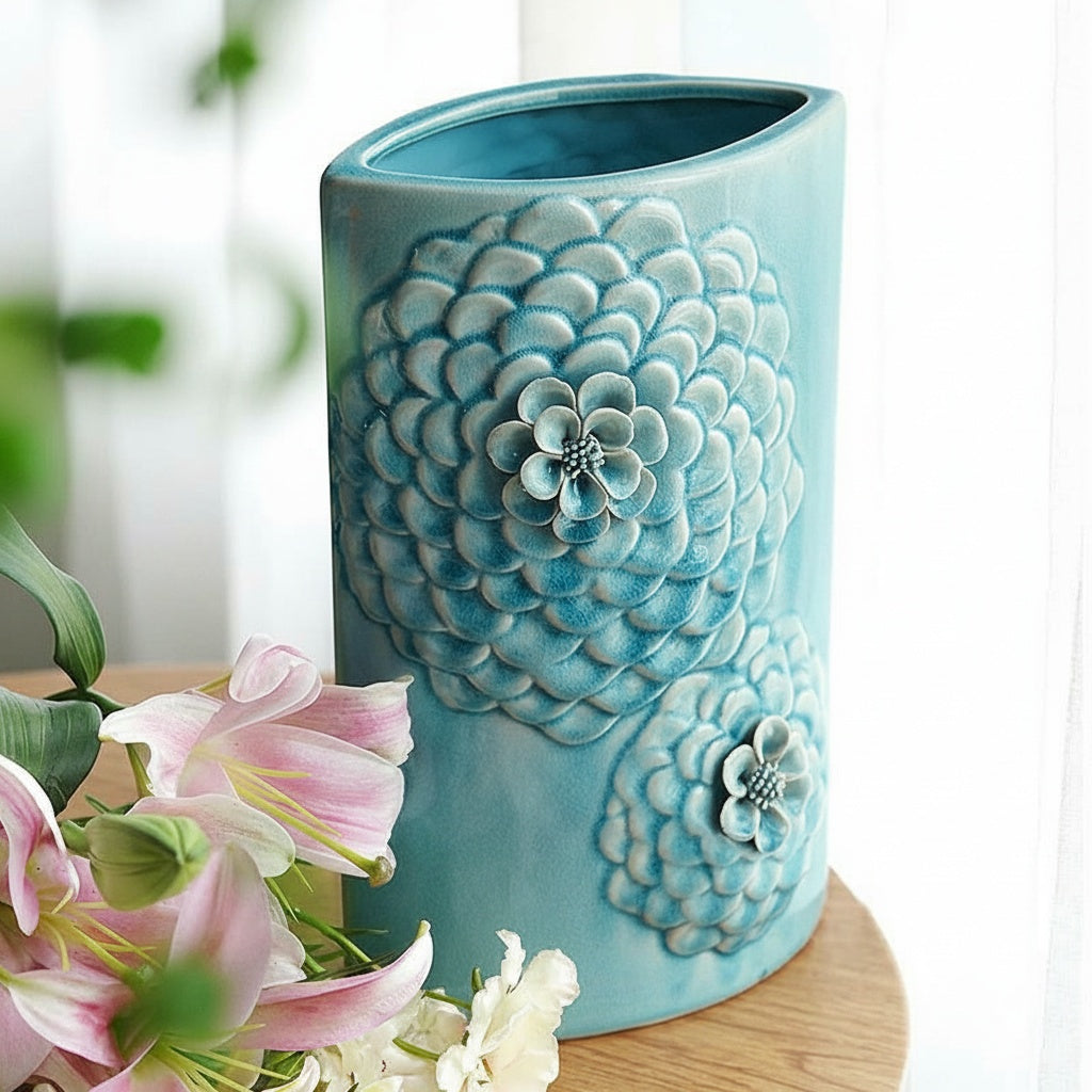 Light blue ceramic vase with sculpted floral relief