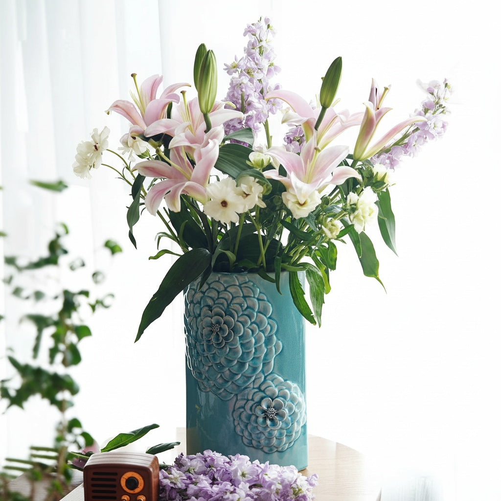 Light blue ceramic vase styled with fresh pink and white flowers