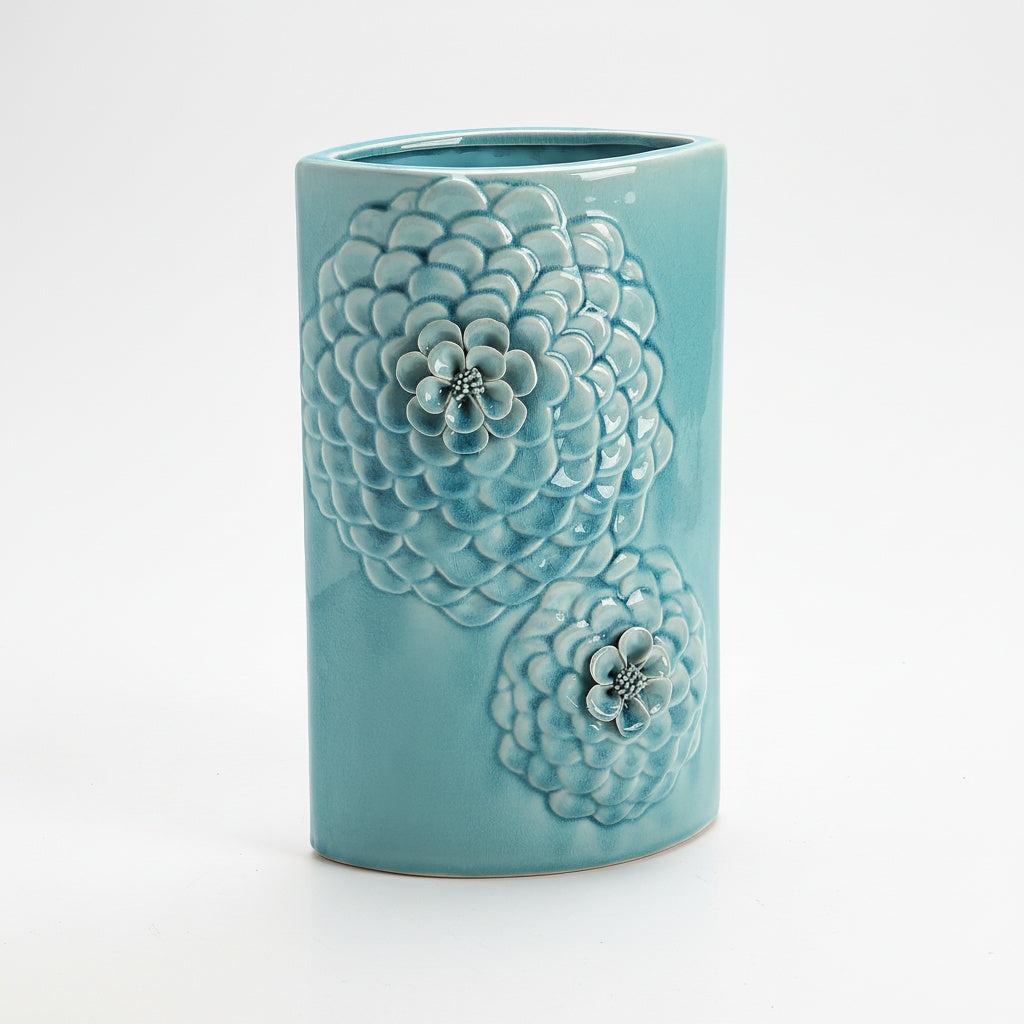 Close up of 3D floral details on light blue ceramic vase