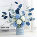 Light Blue Geometric Ceramic Vase with Floral Arrangement
