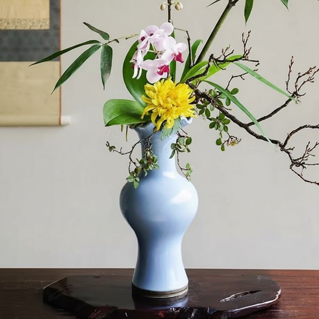 Light Blue Porcelain Ruffled Rim Vase Styled With Flowers