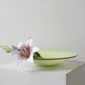 Lime green glazed glass shallow bowl with lily flower styling