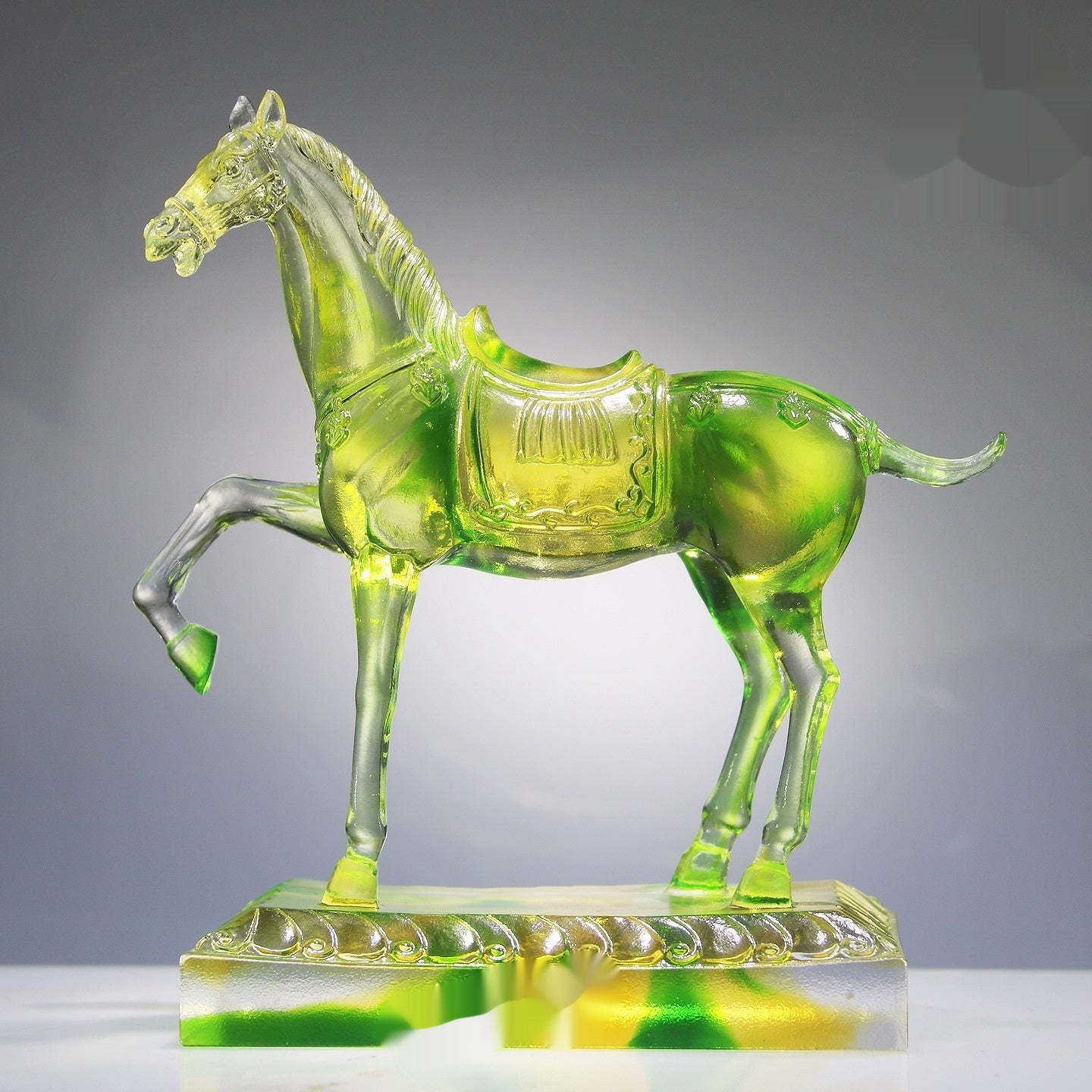 Side profile of translucent lime green and yellow glass horse sculpture