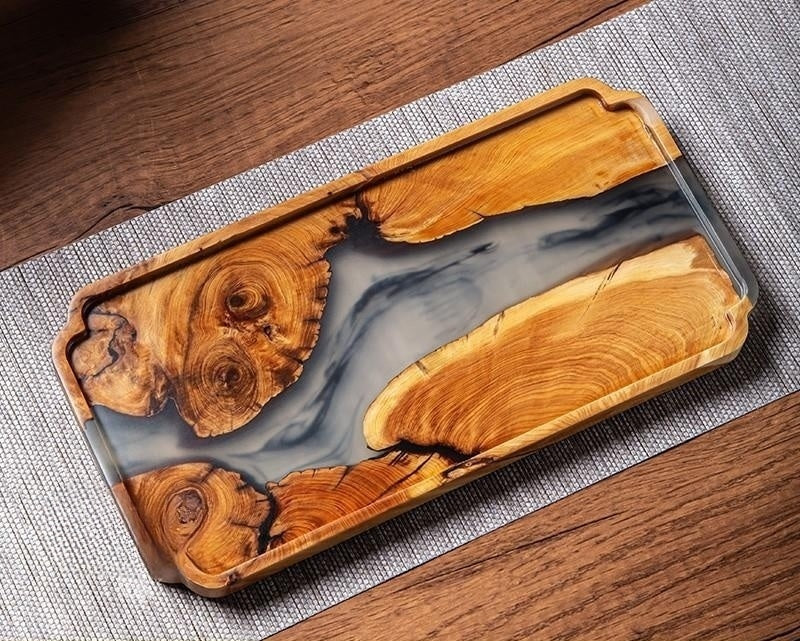 Top down view of rectangular burl wood tray with smoky grey epoxy river insert