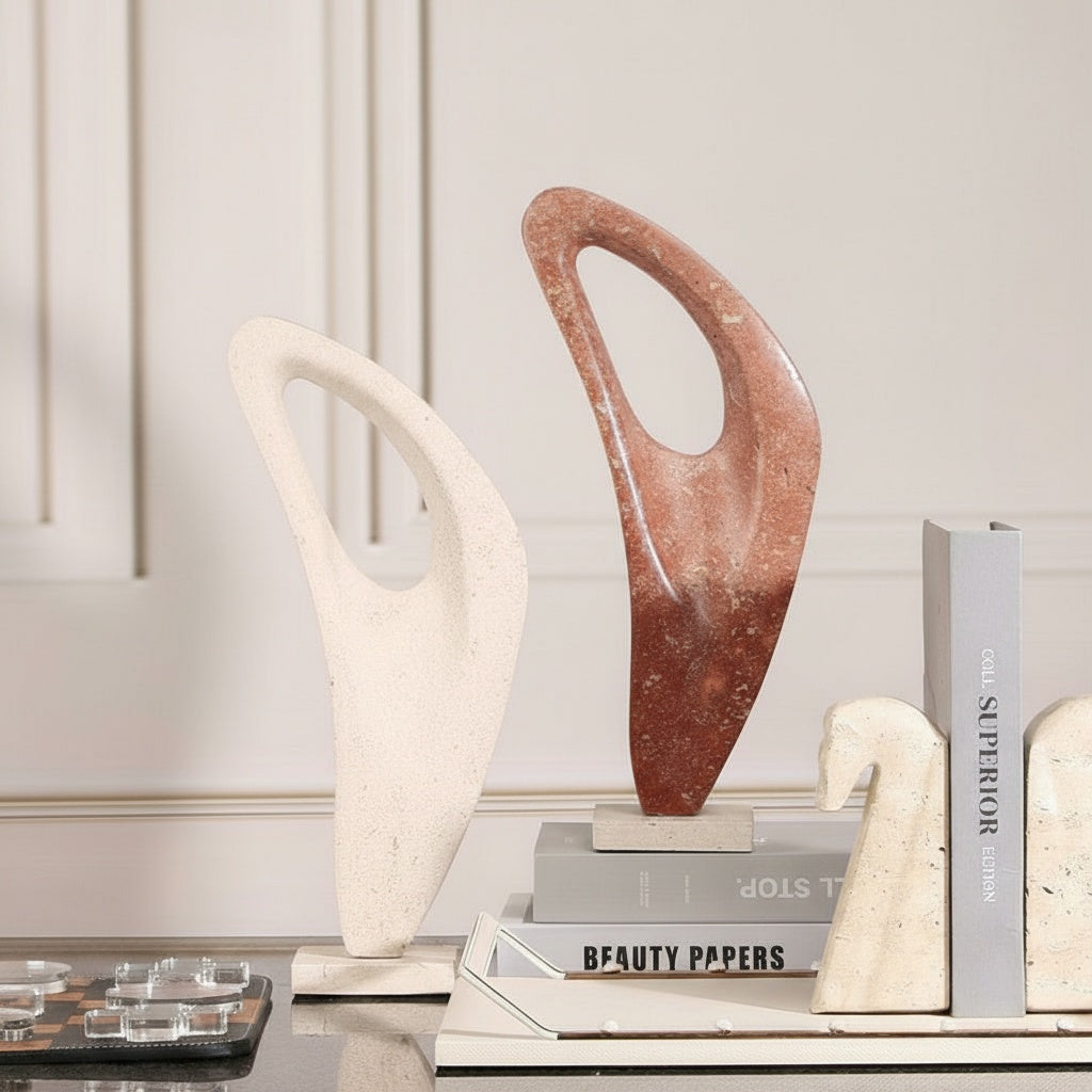 Red and white marble abstract loop sculptures on books