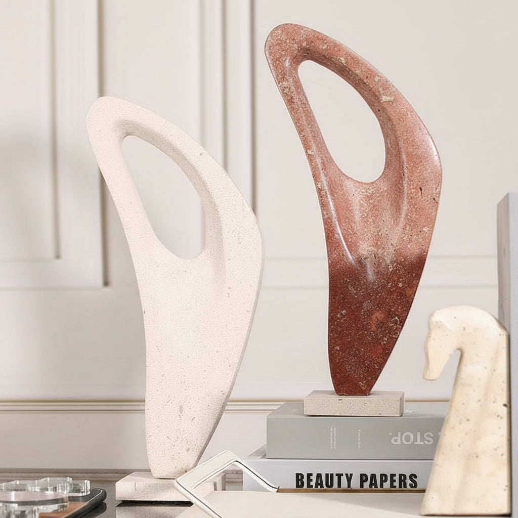 Side view of red and white abstract stone sculptures