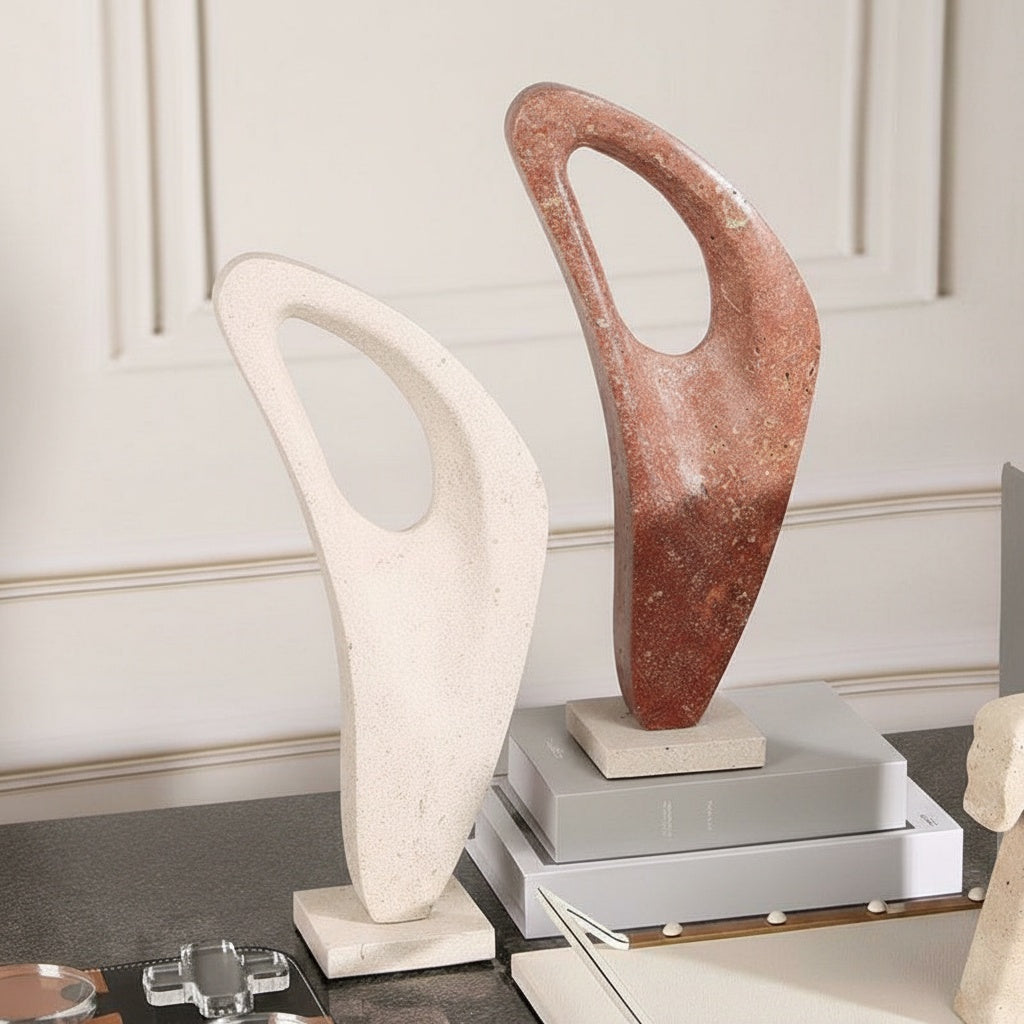 Red marble abstract sculpture on stone base