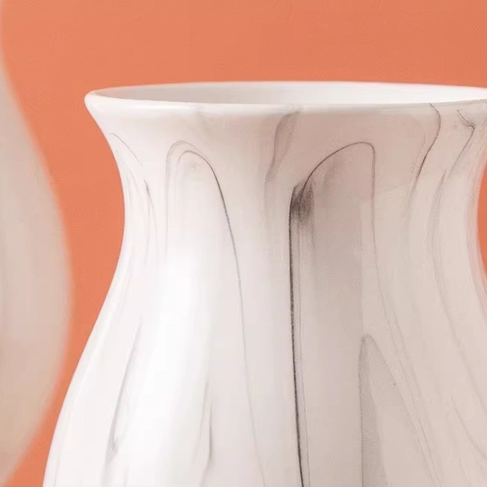 Close-up of white ceramic vase body with gray marble pattern detail