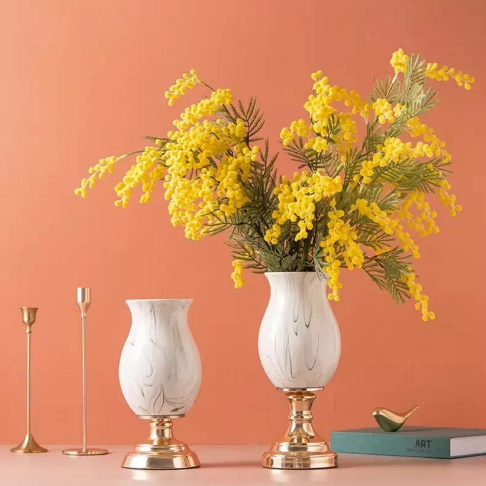 Pair of pedestal vases styled with yellow flowers in an elegant interior setting