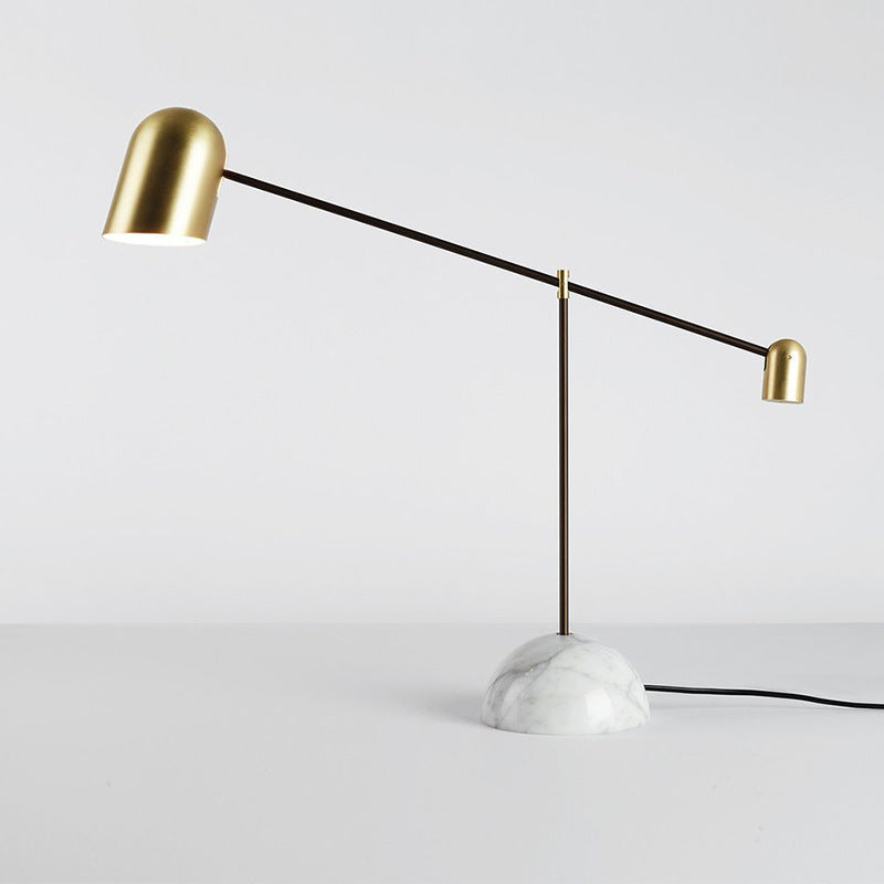 Studio view of marble and brass balance arm table lamp