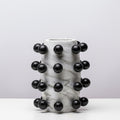 Cylindrical white faux marble vase with black spheres