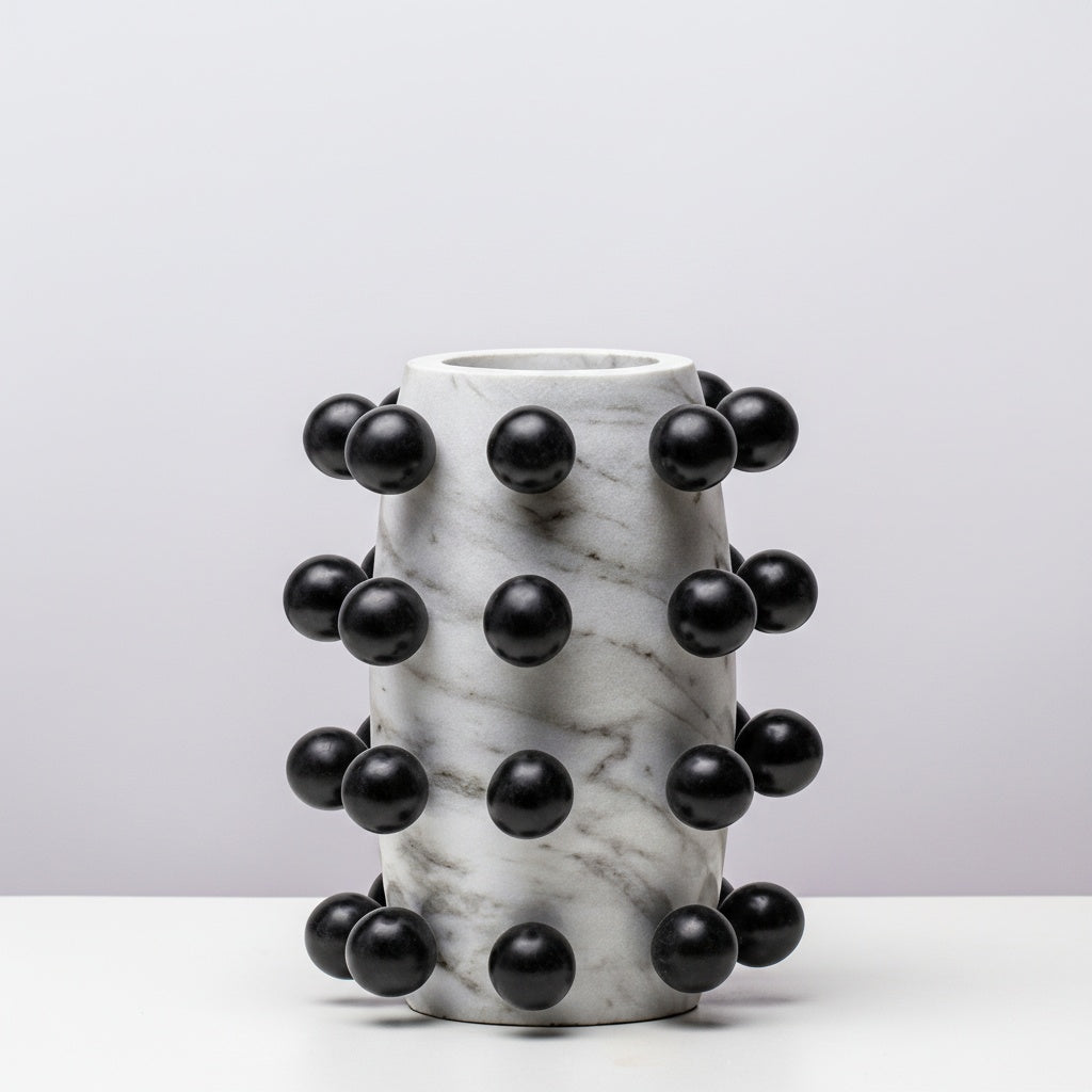 Cylindrical white faux marble vase with black spheres